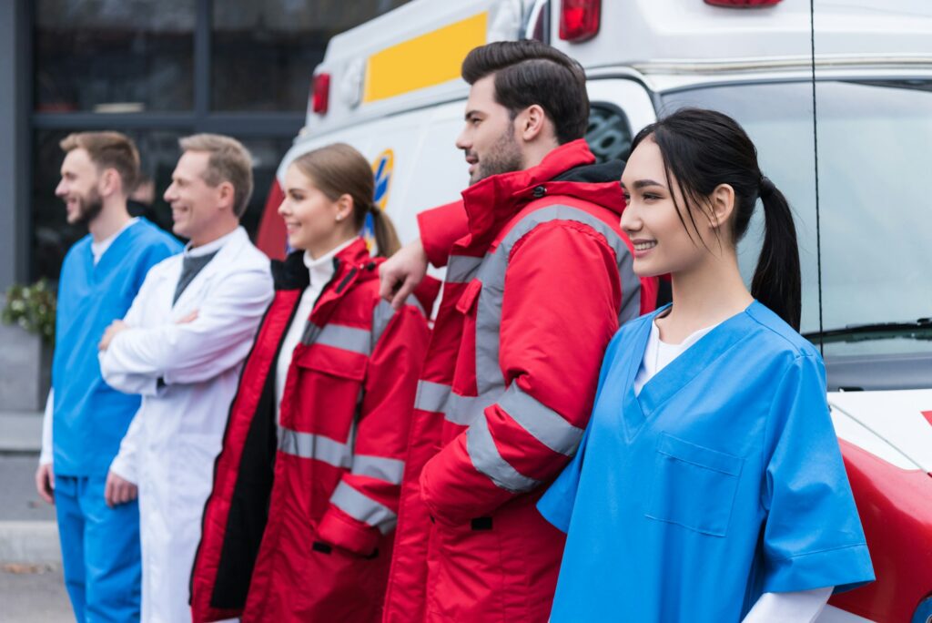 ambulance doctors working team standing and posing in front of car