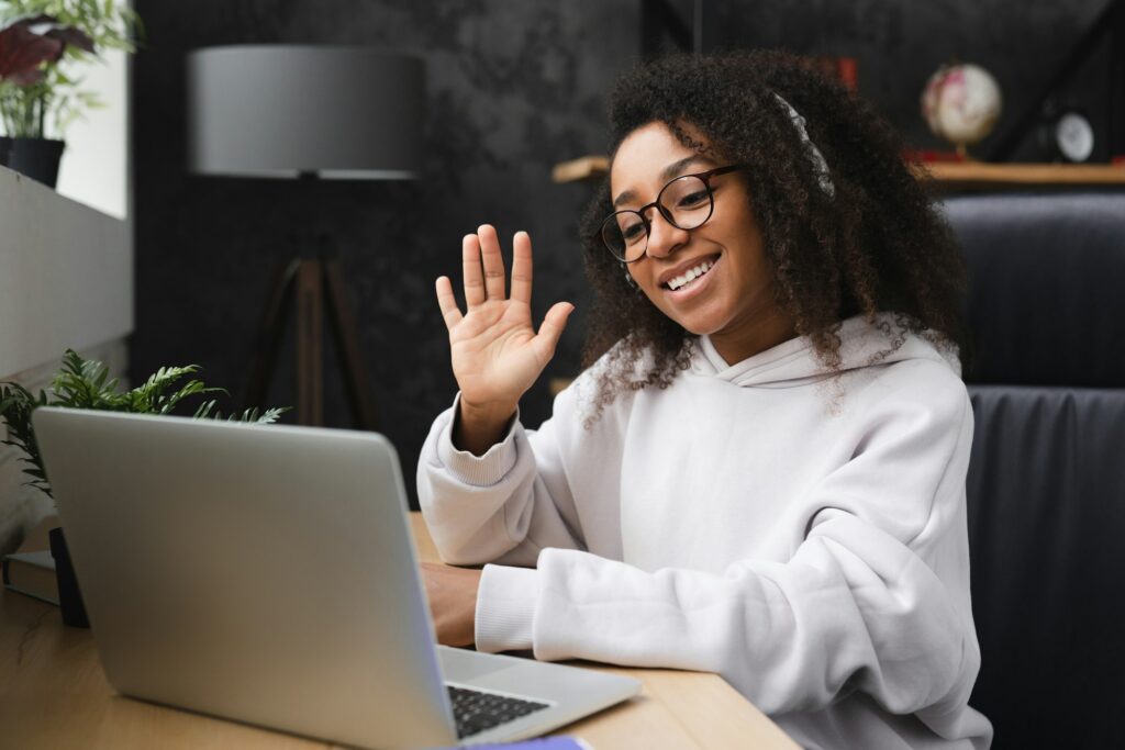 Woman talking online on videocall on laptop, e-learning, working on distance, watching webinars